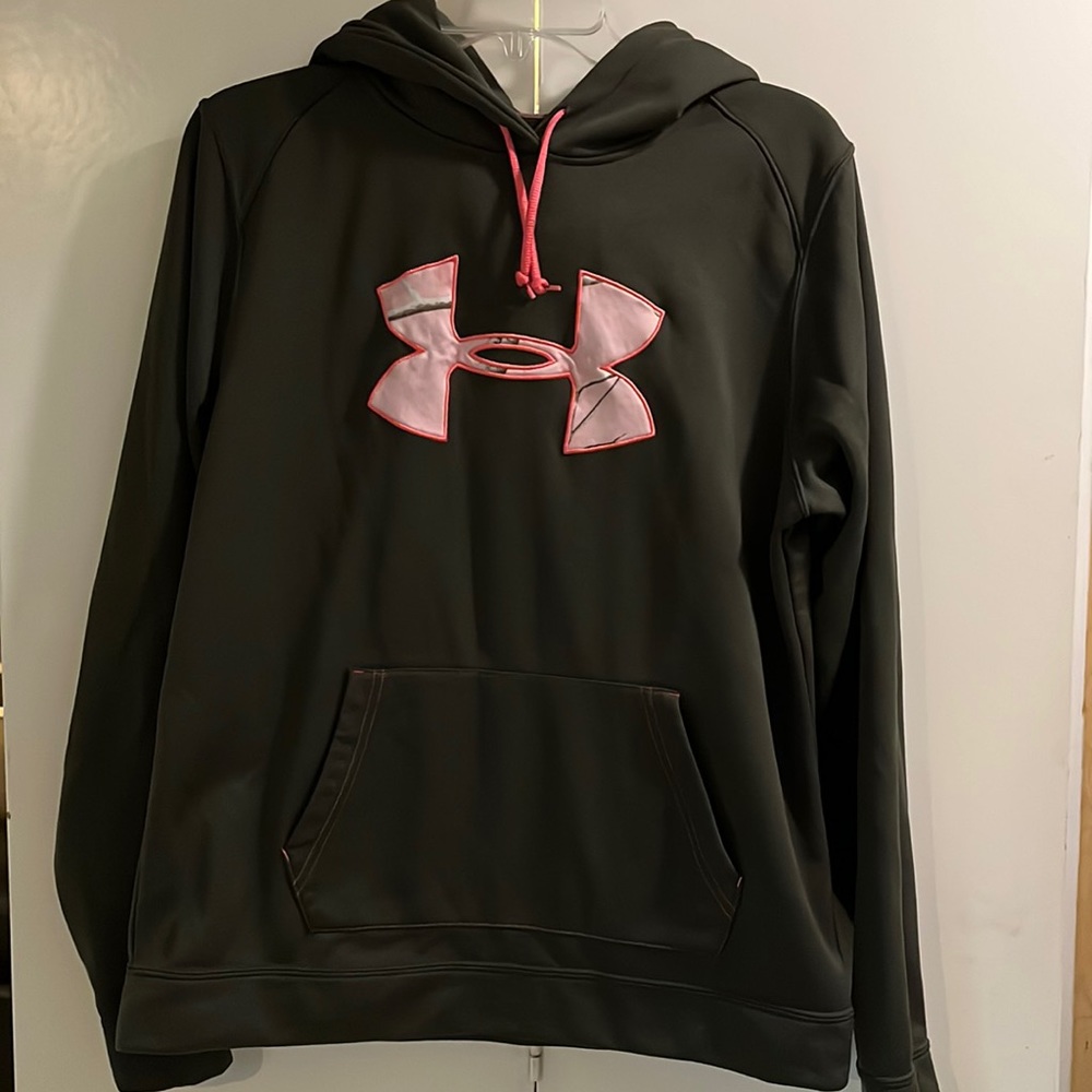 In new condition, under armor olive green with pink camo size large.